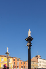 Fototapeta na wymiar Ravenna Italian mosaic capital, Italy - Emilia Romagna, statues on the columns in Piazza del Popolo