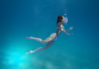 Young guy and girl dive in the tropical sea - imitation of drowning