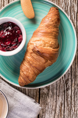 Fresh croissant on wooden board.