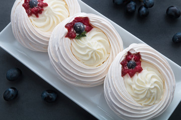 Cakes on a white plate standing on the table.