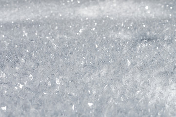 Snow background with detailed snowflakes. A macro photo of real snow crystals: large stellar dendrites with hexagonal symmetry, long elegant patterns and delicate transparent structures