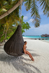 Woman relaxing in Paradise Island (Lankanfinolhu), Maldives