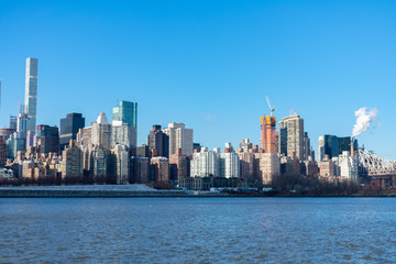 Fototapeta na wymiar Midtown Manhattan Skyline along the East River in New York City with the Queensboro Bridge