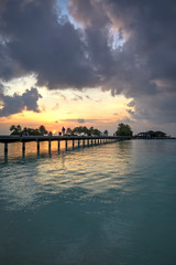 Fototapeta na wymiar Footbridge of Paradise Island (Lankanfinolhu) at sunset, Maldives