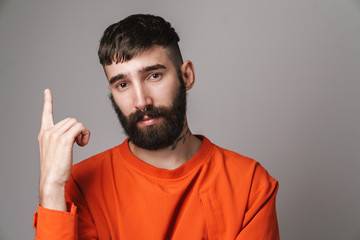 Fototapeta premium Image closeup of young bearded man pointing finger at copyspace