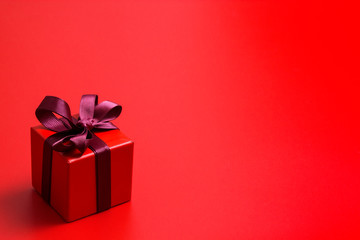Red gift box on red background