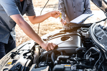 Technician team working of car mechanic in doing auto repair service and maintenance worker...