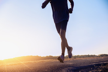 The man with runner on the street be running for exercise.