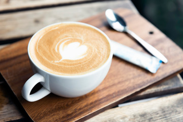 Cup of coffee with latte art on table