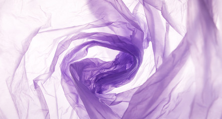Swirl Pattern of purple trash bag over white background
