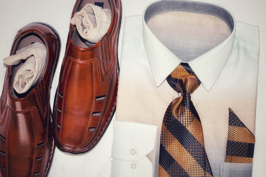 Men’s White Dress Shirt With A Gold And Black Tie And Brown Dress Shoes 