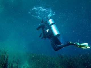 Underwater view of scuba diver in search and rescue exercise.