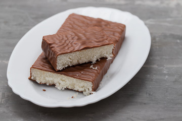 coconut turron with chocolate on a ceramic background
