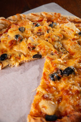 Pizza on a wooden dark background in a bar