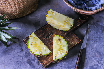 Photo of fresh pineapple on table. Whole and sliced pineapple on wooden cutting board.  Top view. Summer fruit. Tropical Fruit. Image.
