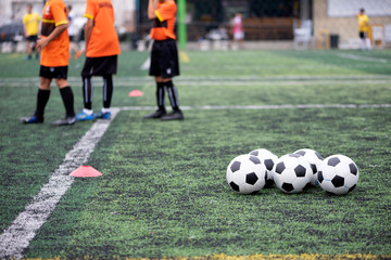 Training Balls in green soccer field