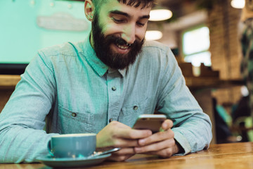 Attractive young bearded man wearing shirt