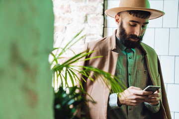 Attractive young bearded man wearing coat