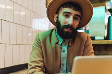 Attractive young bearded man wearing coat