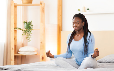 Black Girl Doing Morning Yoga In Bed At Home