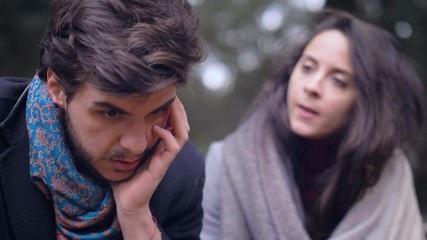 couple fighting on a bench at the park -disagreement, conflict - Powered by Adobe