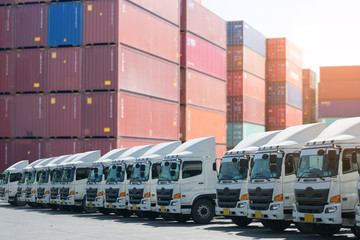 New haulage truck fleet is parking in the container depot as for shipping, logistics, business transportation background. - obrazy, fototapety, plakaty