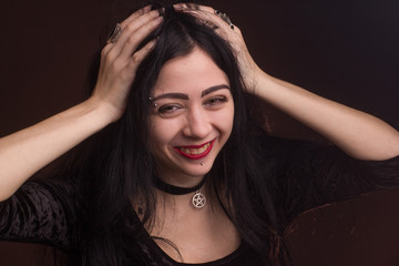 brunette on dark background dressed in goth style