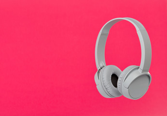 Headphones on pink background