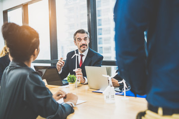 Business people having consultation about wind energy at company office. Business team discussing about windmill and alternative green enery. Executive meeting for investing budget and fund for profit