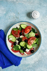 Greek salad from fresh vegetables and feta cheese. Top view with copy space.