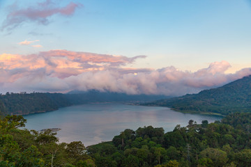 Beautiful sunset over lake Buyan. Scenery nature landscape. Amazing view on volcanic mountains and  cloudy sky. Bali island, Indonesia.