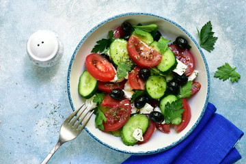 Greek salad from fresh vegetables and feta cheese. Top view with copy space.