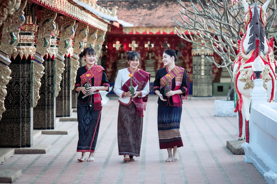 Three Thai girl In the Phu Thai tribe Standing in the Thai temple area