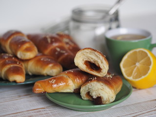 Ready-made toasted homemade bagels on a black baking sheet from the oven. Ready to eat. Sprinkled with sesame seeds. Home kitchen.