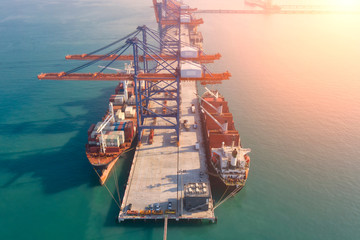 Container ship in export and import business and logistics. Shipping cargo to harbor by crane....