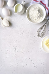 Culinary background with ingredients for baking : egg, flour, butter and milk. Top view with copy...
