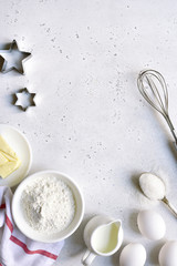 Culinary background with ingredients for baking : egg, flour, butter and milk. Top view with copy space.