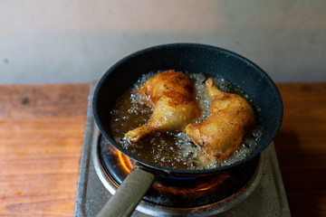 Fry the chicken in a pan with boiling oil.