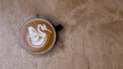 Shot from above for a cup of coffee with latte art. Swan