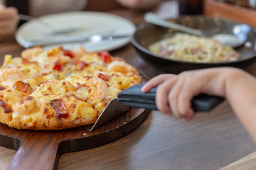 Seafood Italian Pizza slice on wood dish