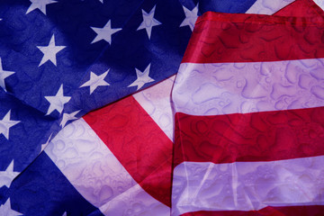 Rain on the American Flag. Rain drops on the wet American Flag. Close up of an USA flag with raindrops background.