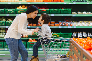 mother and her son buying fruits at a farmers market