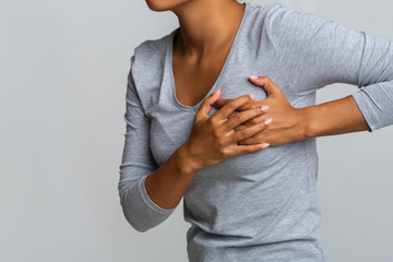 Young woman feel menstrual cyclic breast pain, touching her chest