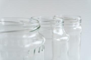 Close-up glass jars at gray monochrome background. Zero waste concept.