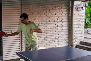 a young men playing table tennis
