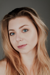 portrait of blonde girl with blue eyes and big bokeh