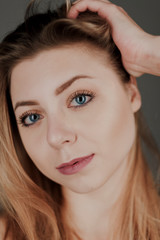 Obraz premium portrait of blonde girl with blue eyes and big bokeh