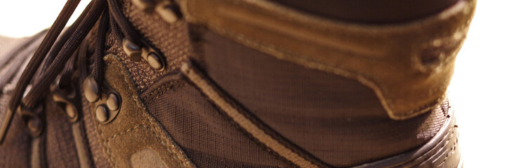 waterproof hiking boot brown mountain climbing shoes with black lace and metal eyelets hooks close up view