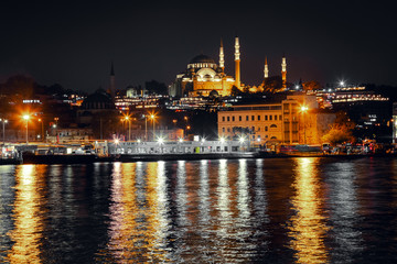 Evening view of the Golden Horn Bay with the Eminonu Pier on the background of the Suleymaniye Mosque.