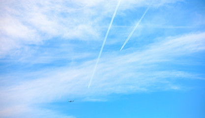 Two airplanes and beautiful blue sky with clouds
